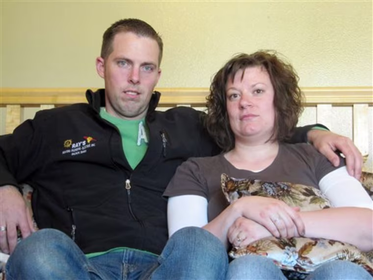 In this photo taken June 9, 2011, Ben and Amber Sessions pose for photos at their rental home in Rexburg, Idaho. The five-bedroom house on a nearly 2-acre lot in the eastern Idaho countryside the Sessions bought in 2009 seemed like a steal at $178,500. But it wasn't long before the couple realized the dream home they had purchased for their growing family was their worst nightmare: It was infested with hundreds upon hundreds of garter snakes. (AP Photo/Jessie L. Bonner)